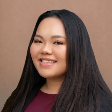 Portrait of a smiling woman with long black hair against a plain brown background.