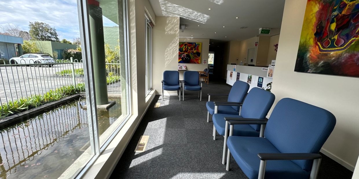 Dr Selina Lim GP Clinic MEDICAL CENTRE waiting room with paintings and water feature