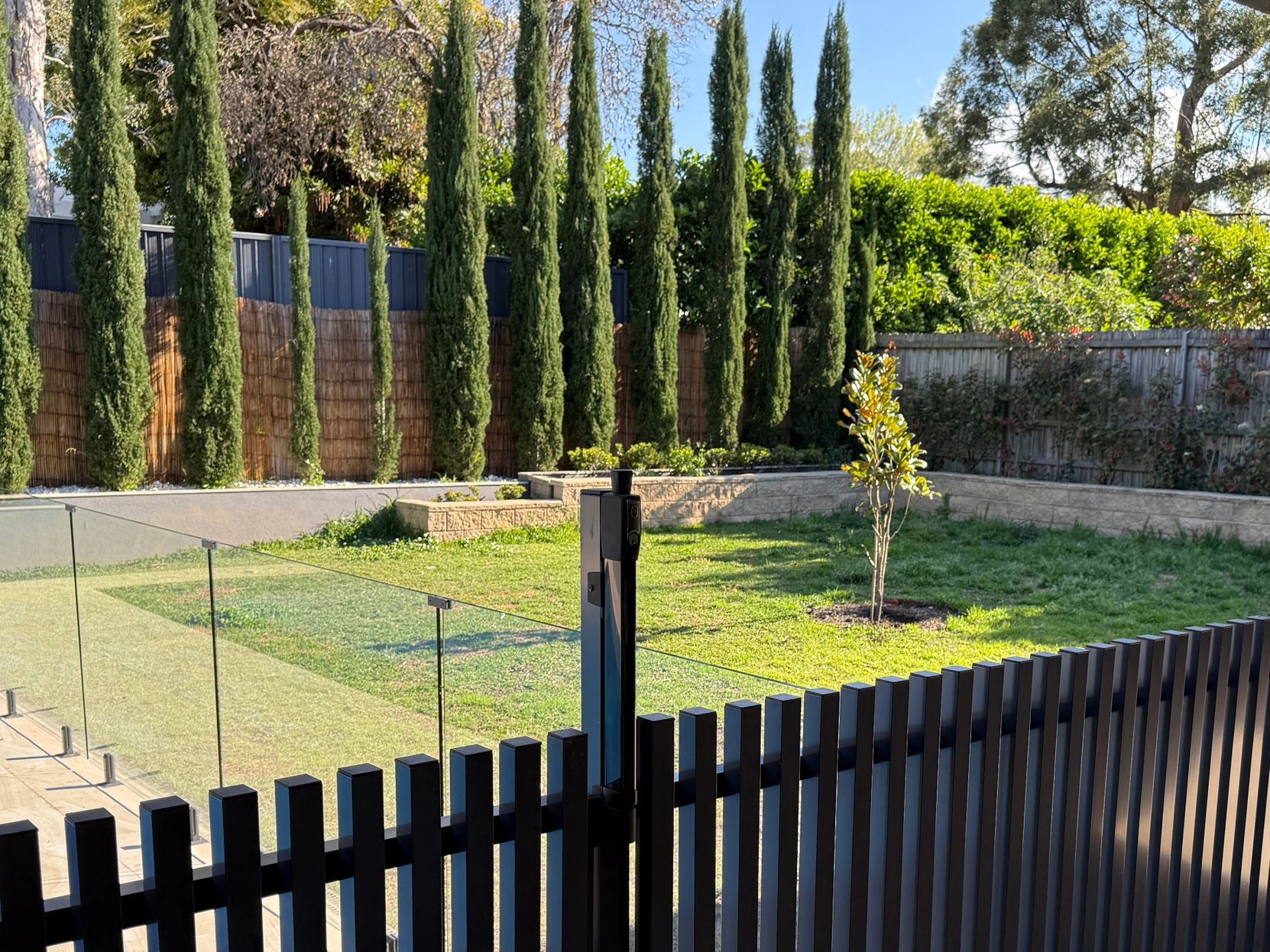 Custom made aluminium fencing and frameless glass pool fencing installed for a modern Sydney home.