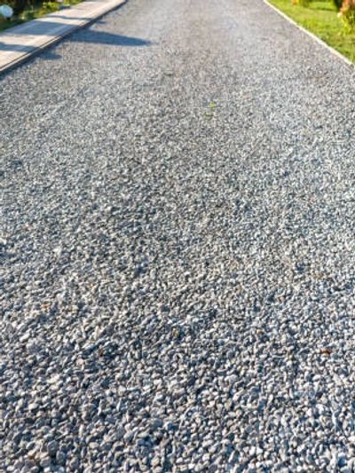 Close-up of a gravel pathway under sunlight.