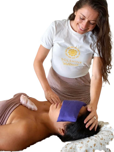 Woman giving a relaxing massage with eye pillow.