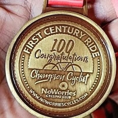 A wooden medal for the First Century Ride, celebrating a 100-mile cycling achievement.