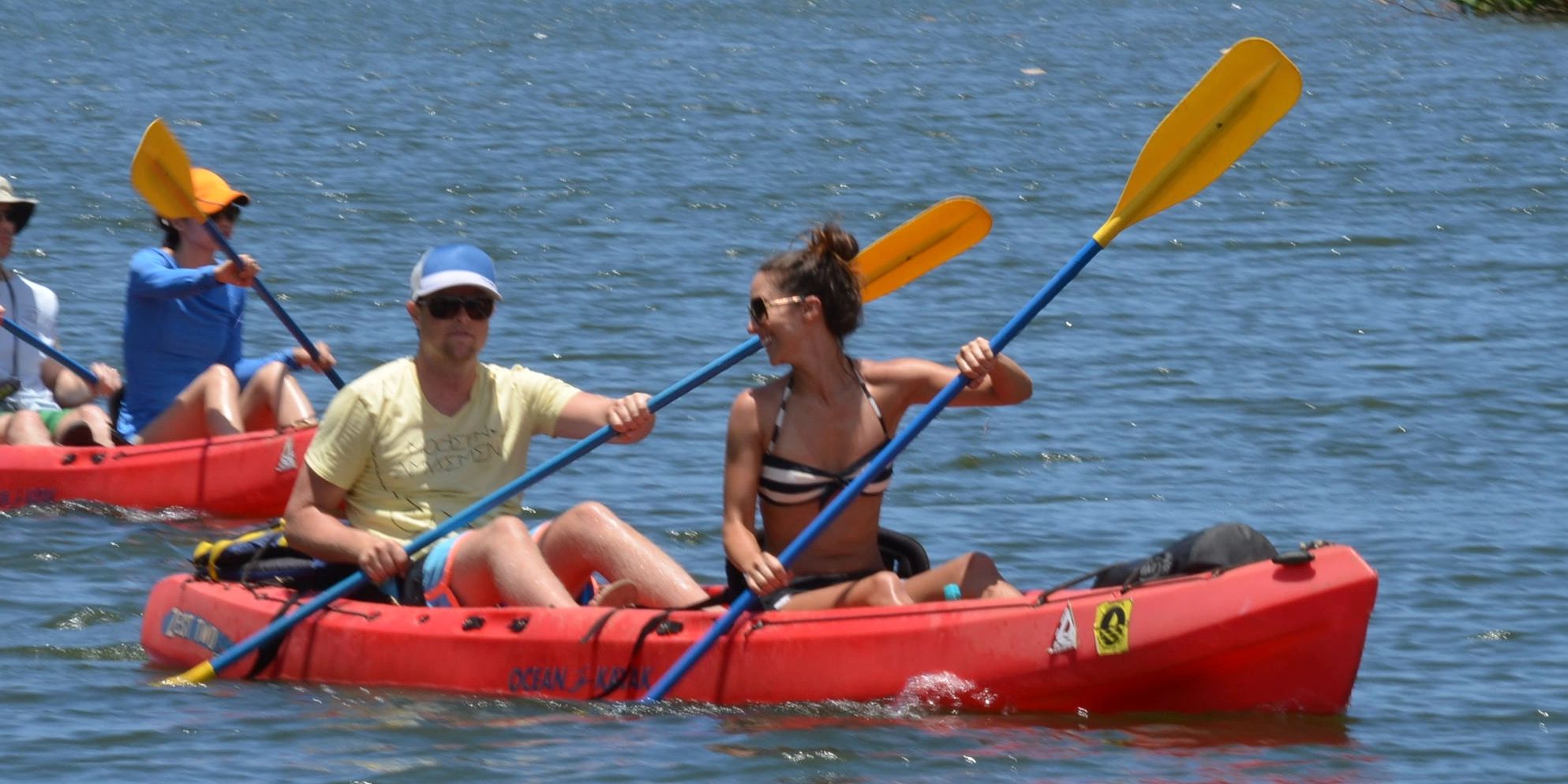 kayaking on a river with two people smiling
