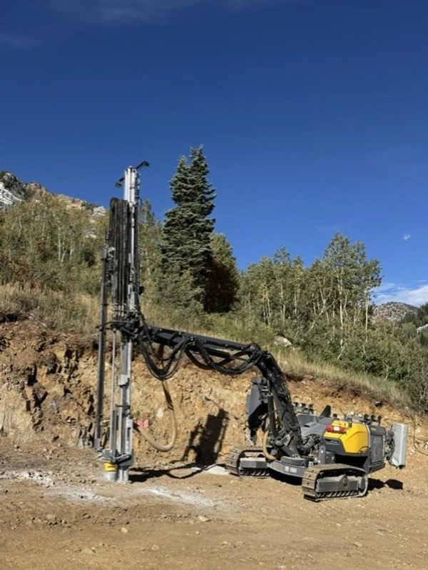 Uinta Specialties track drill on a Utah mountain rock excavation