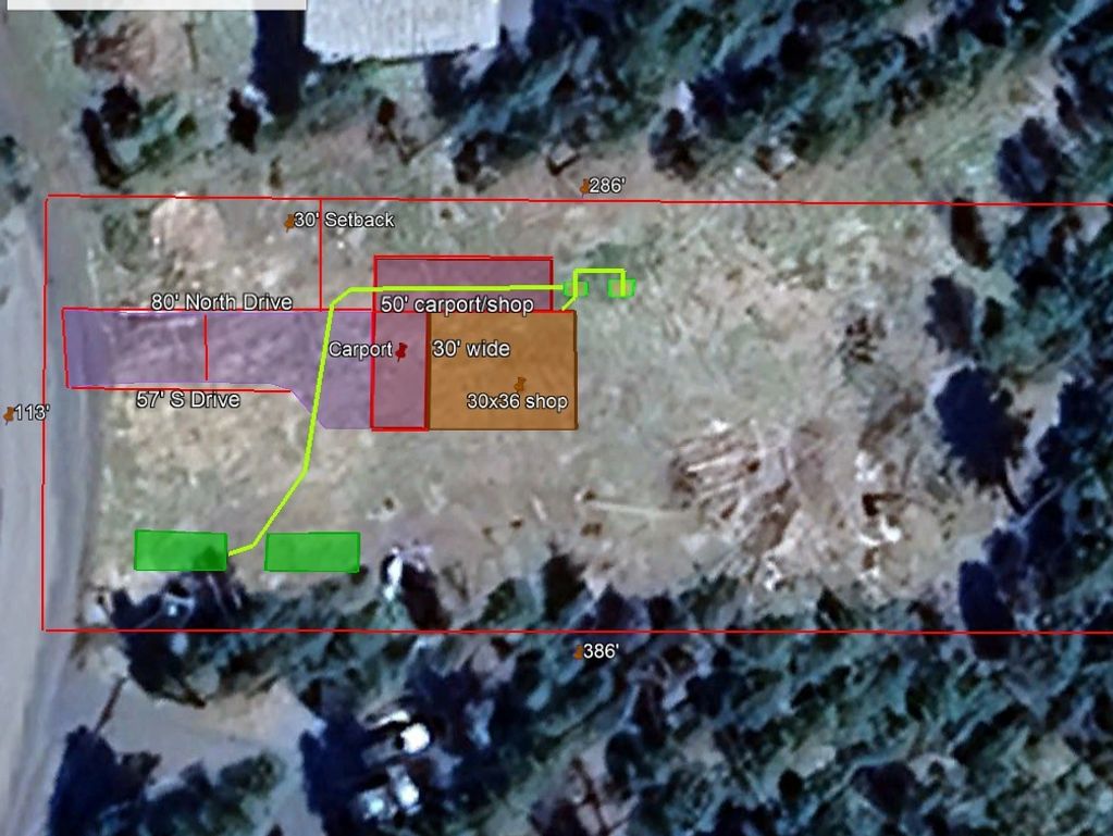Aerial view of a property with measurements and labels for carport, shop, driveways, and setbacks.