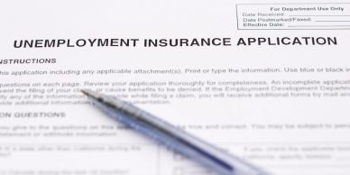 Close-up of an unemployment insurance application form with pens.