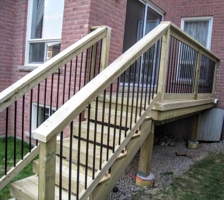 Deck stairs up to oversized landing at back patio doors