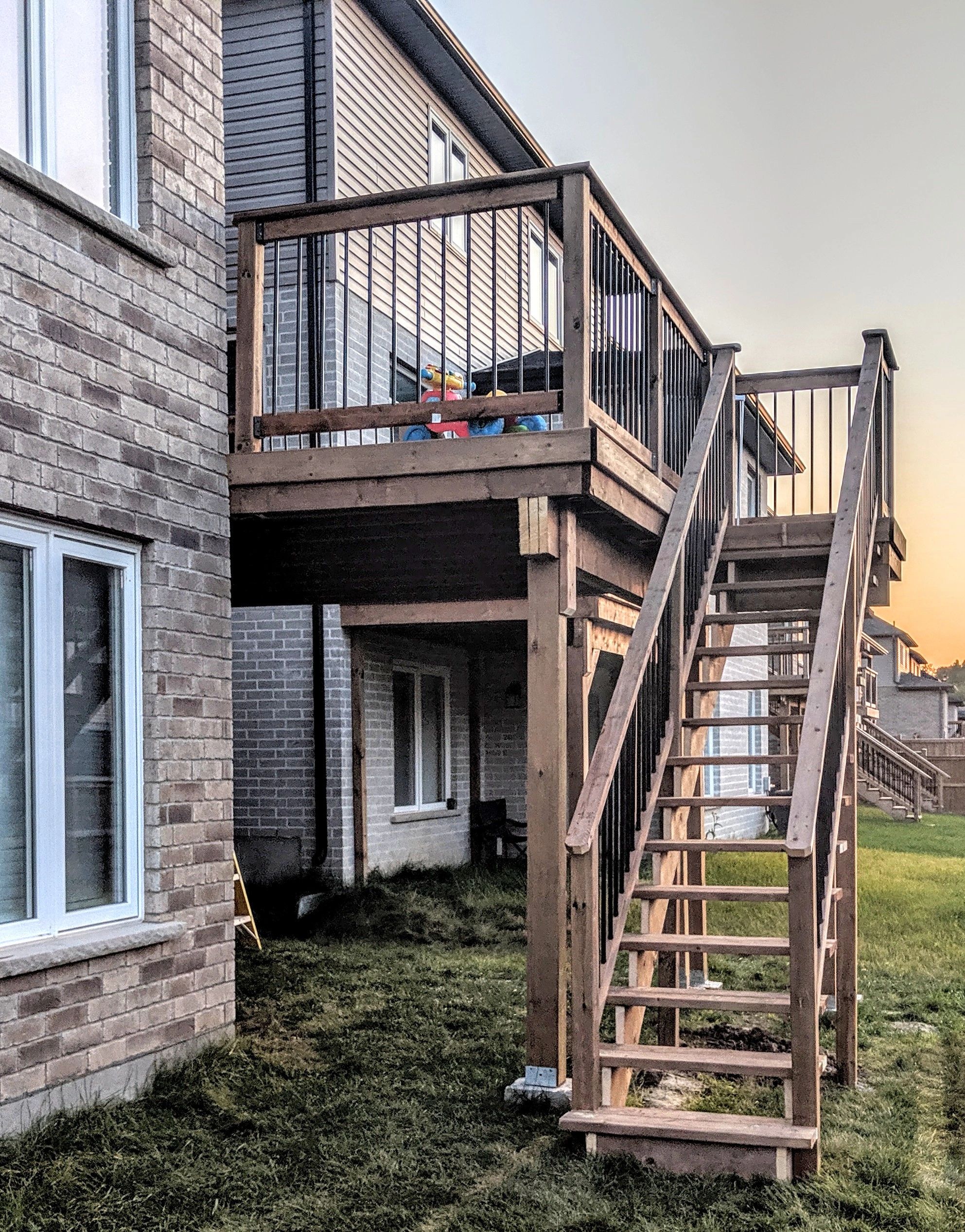 2nd story deck with pressure treated lumber and black aluminum spindles