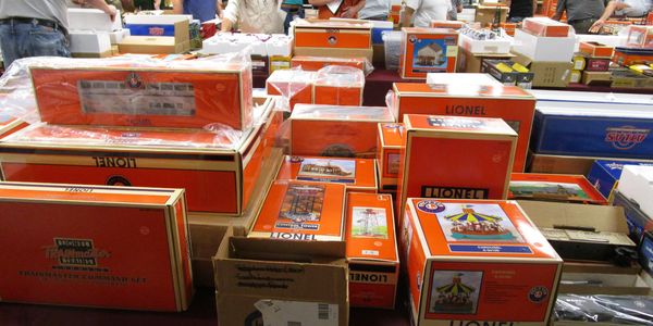 Shelves filled with boxed Lionel train sets and miniature railway add-ons.

