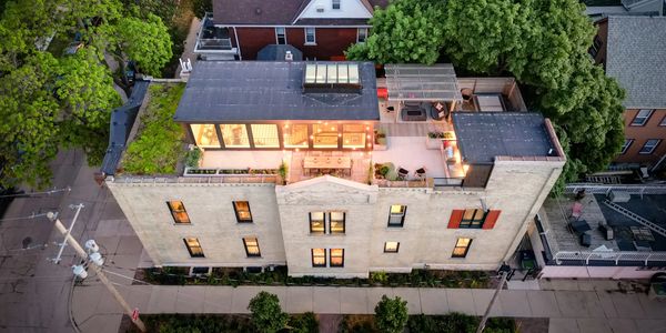 Rooftop apartment with illuminated terrace and seating area.
