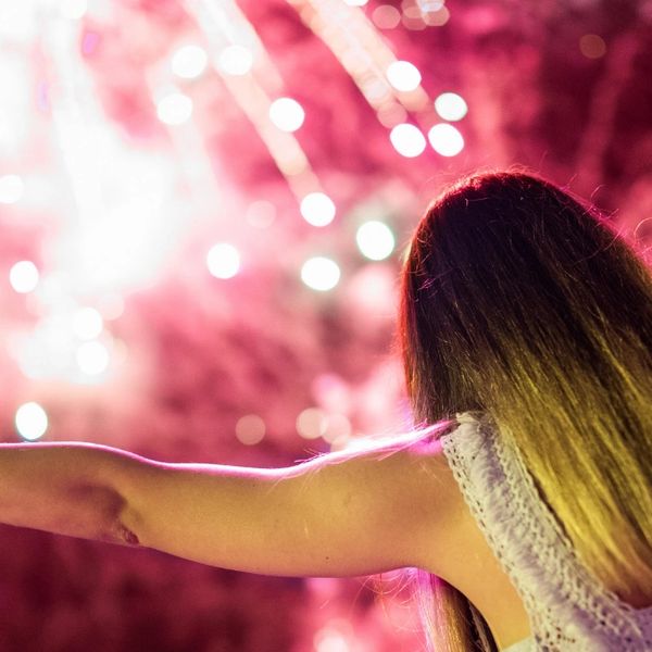 Young woman embracing life's finer moments - Fireworks