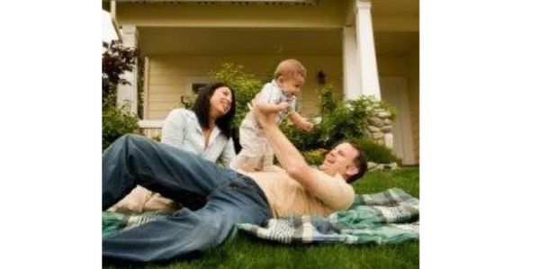 Family on blanket in front yard. 