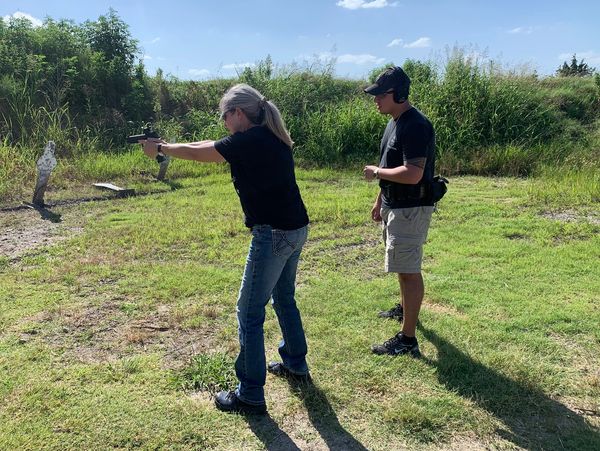 Blake Hill providing basic instruction to a new shooter on the range. 