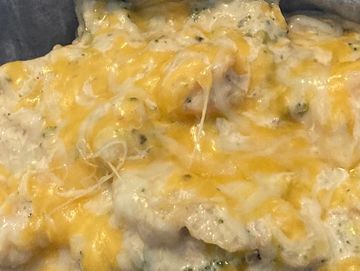 Baked potato filled with grilled marinated salmon, broccoli, cheese, and homemade alfredo sauce serv