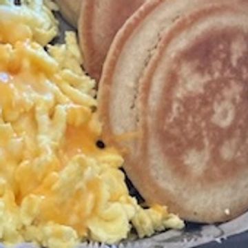 Pancakes and scrambled eggs with cheese 