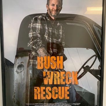 Man leaning on a truck with 'Bush Wreck Rescue' text.