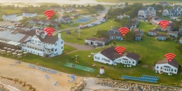 Aerial view of a beach resort with Wi-Fi signals over buildings.