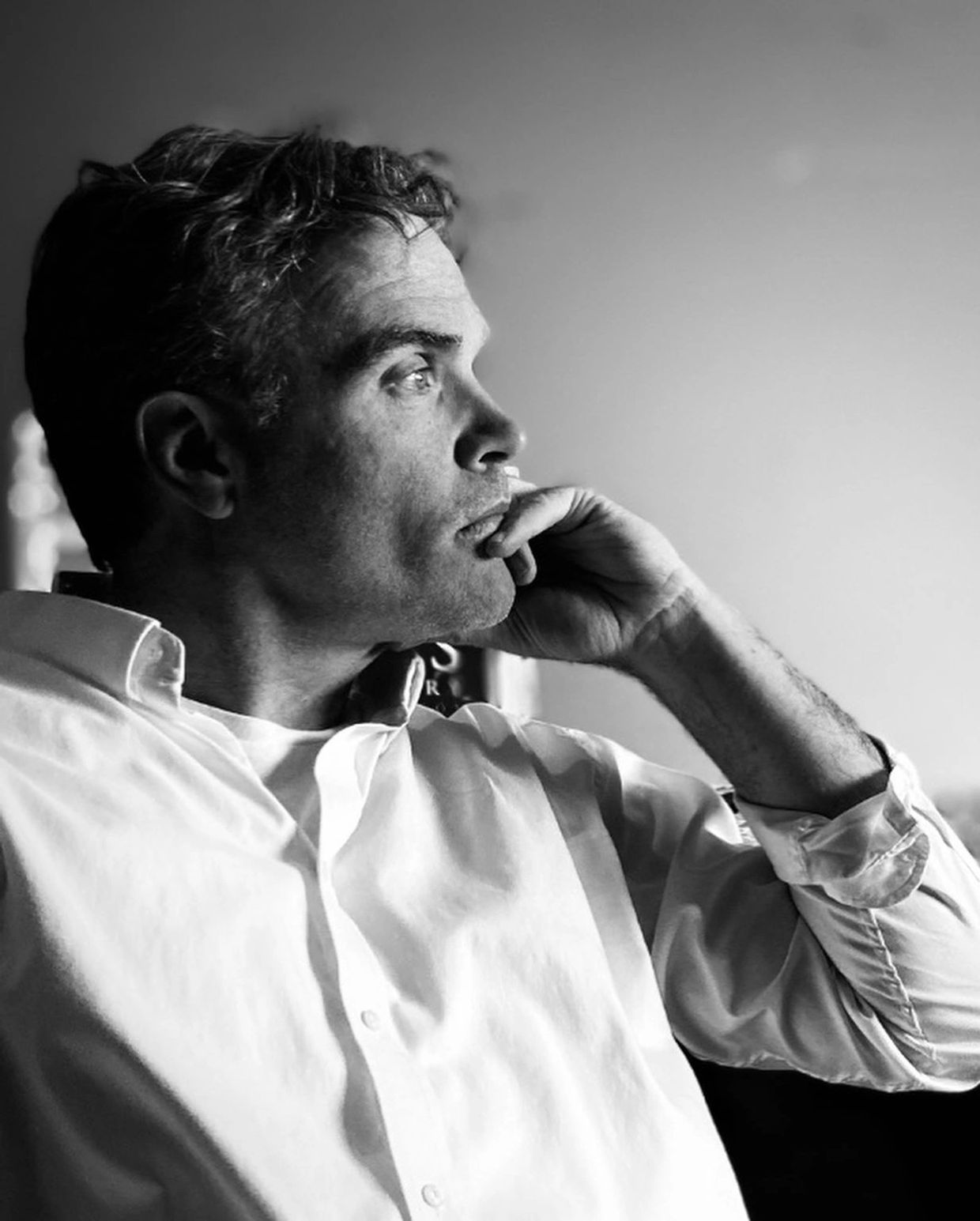 Man in deep thought looking out the window.