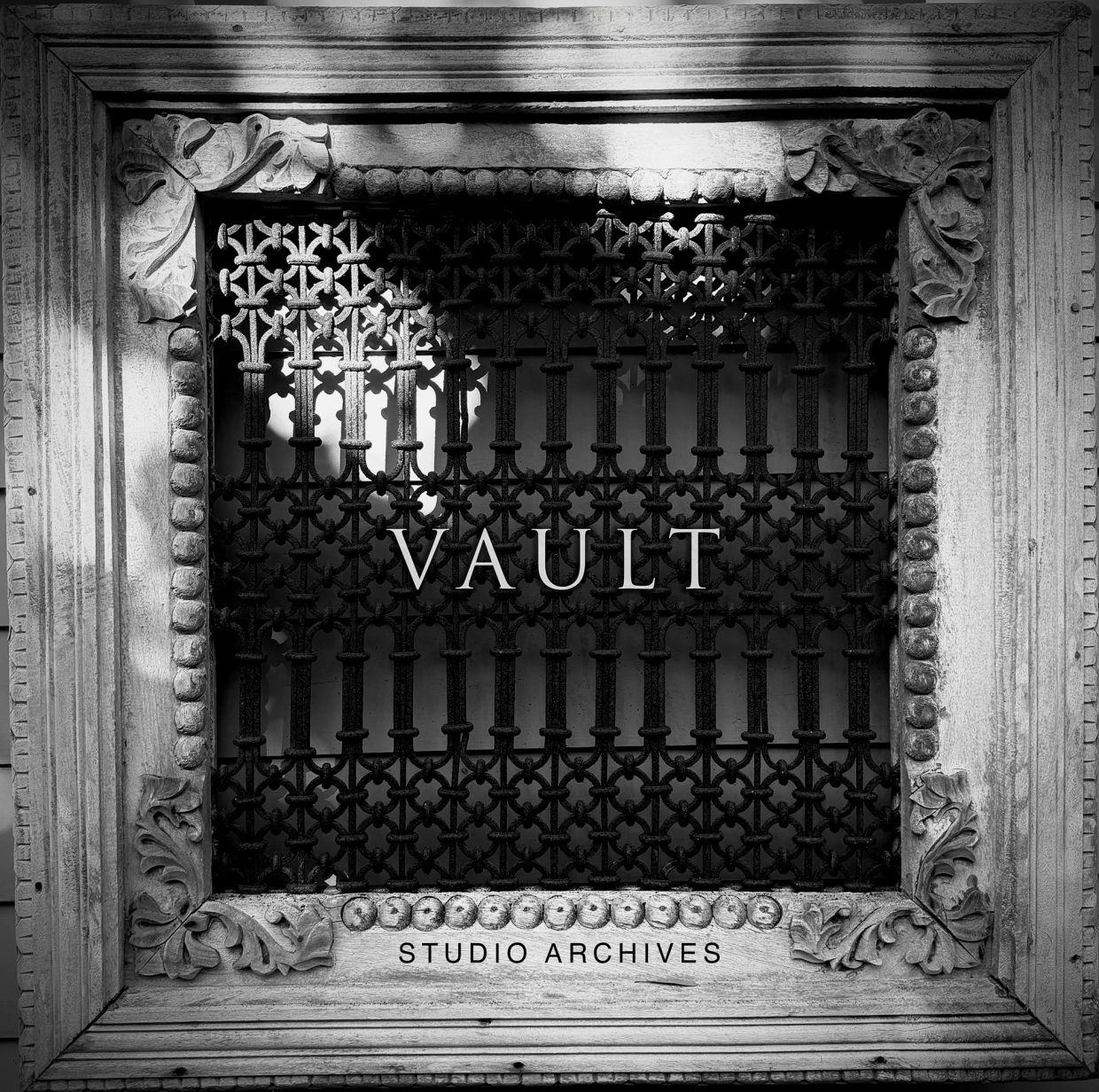 Ornate metal vault door framed with stone.