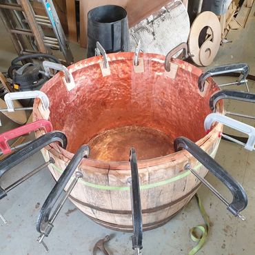 Lining whiskey barrel with copper.