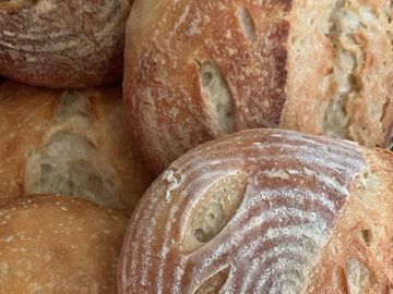 Close-up of freshly baked artisan bread with crusty texture.