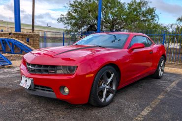 Red Chevrolet Camaro parked outdoors.