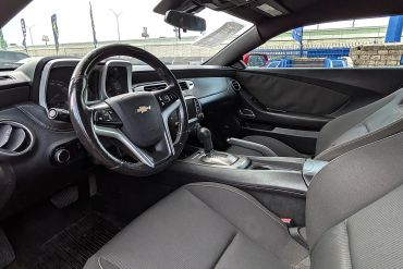 Interior view of a Chevrolet Camaro showing the driver's seat and dashboard.
