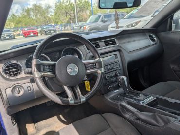 Interior of a car focusing on the steering wheel and dashboard.