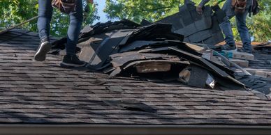Roofing crew removing old shingles during roof repair project by BrightView Construction