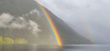 Rainbow with mountain and a large body of water