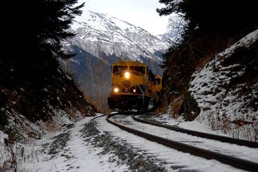 Image of a train engine approaching from between a mountain pass