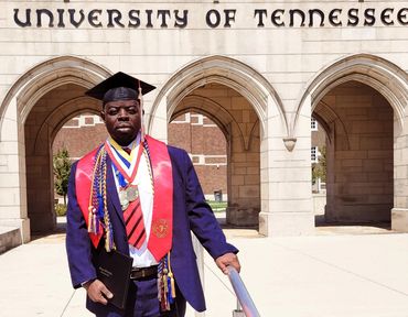 A man with a graduation cap at a university campus