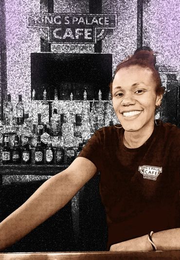 A woman smiling at a bar