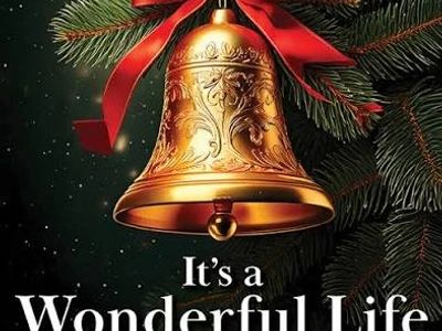 A golden Christmas bell with a red ribbon and pine branches.