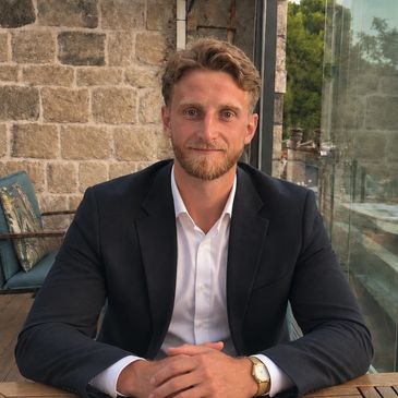 Man in a suit sitting at a table.