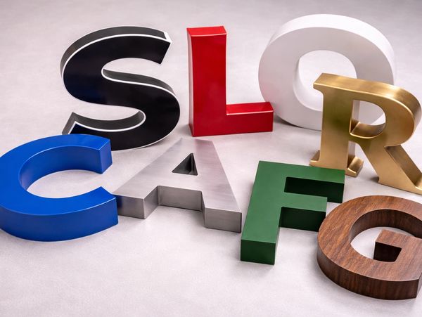 Colorful 3D letters arranged on a light surface.