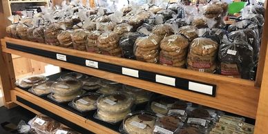 Shelves stocked with various packaged breads and baked goods.