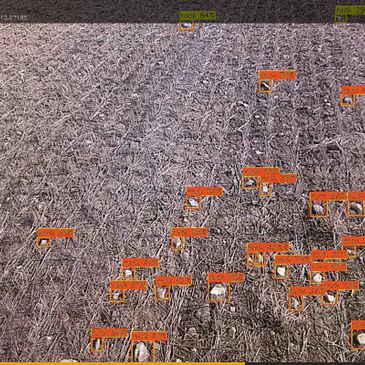 Drones detected and labeled over a textured surface in an aerial view.