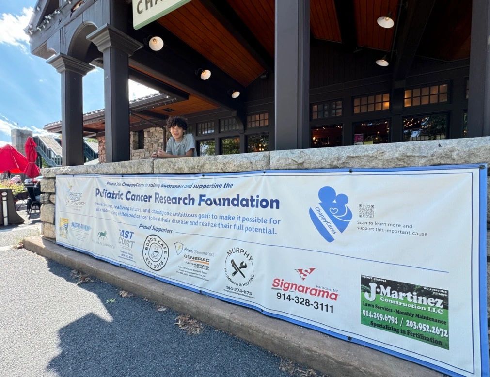Banner promoting Pediatric Cancer Research Foundation with a young boy behind it.