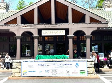 Building with a Chappaqua sign and a foundation banner outside.