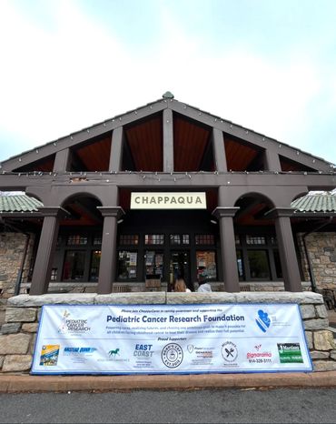 Chappaqua station with Pediatric Cancer Research Foundation banner.