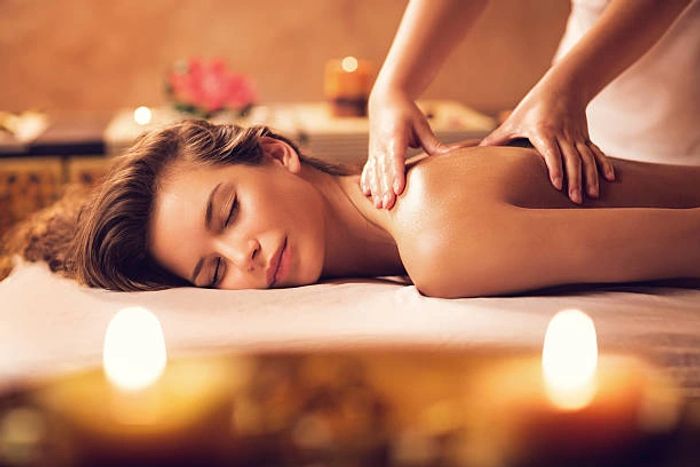Woman enjoying a relaxing back massage in a spa.