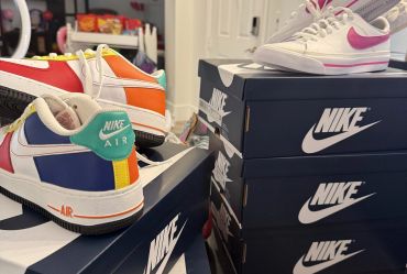 Nike Air sneakers and boxes arranged indoors.