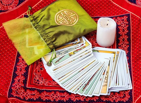 A deck of tarot cards on a red oriental background
