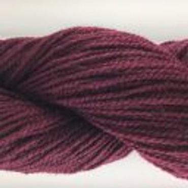 Close-up of deep burgundy yarn twisted into a skein.