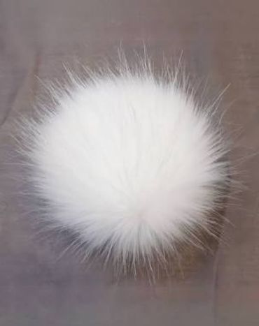 Fluffy white pom-pom with soft, wispy fur on a neutral background.