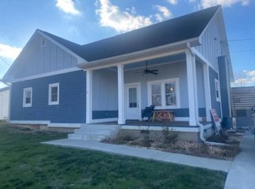 Blue house with white trim and front porch.