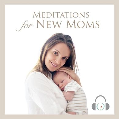 White woman snuggling a young baby in a striped onesie to her chest.