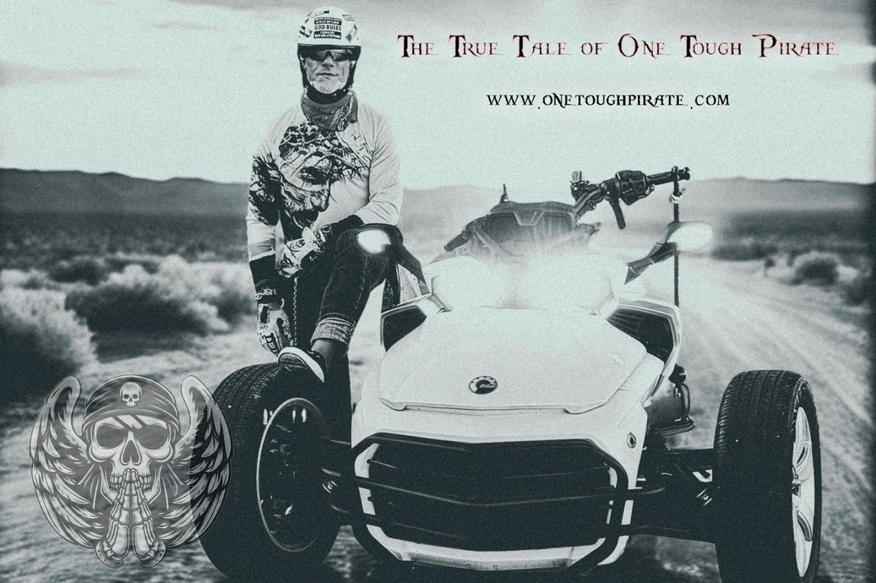 Man standing next to a three-wheeled vehicle in a desert setting.