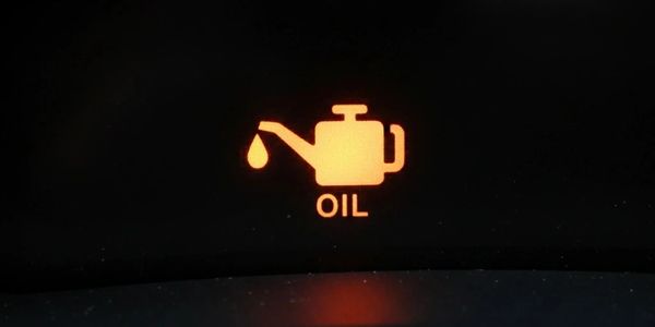 Car dashboard oil warning light indicating low oil level or oil pressure.